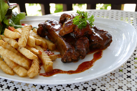 pork spare ribs barbecue serving with french fried and lettuce salad
