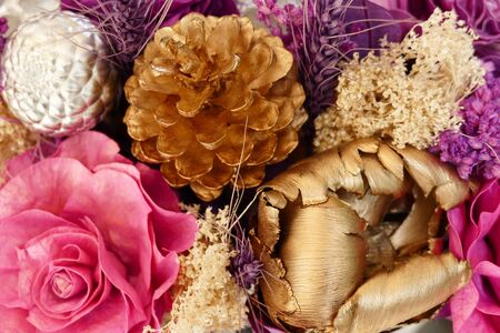 bouquet of blooming artificial pink, purple and yellow flowerの写真素材