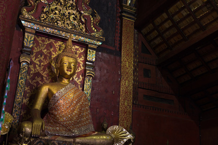 meditating golden budddha statue in ancient templeのeditorial素材