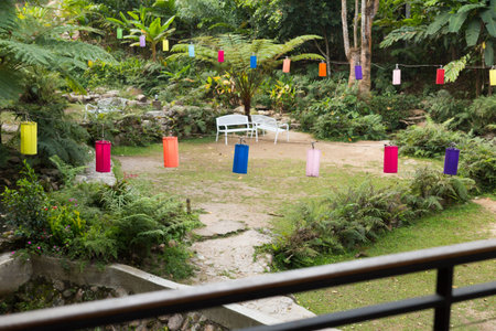 white bench and colorful fabric lantern decorating in the park