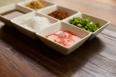 set of thailand condiment seasoning for rice gruel (fried garlic, dried chili, sugar, fish sauce, vinegar, vegetable)の写真素材
