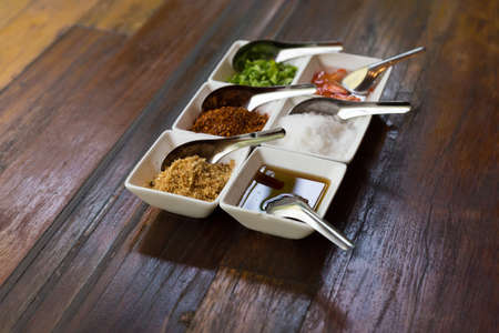 set of thailand condiment seasoning for rice gruel (fried garlic, dried chili, sugar, fish sauce, vinegar, vegetable)の写真素材