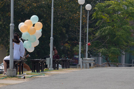 Chiang Mai, Thailand - man and woman holding balloon in the park in Chiang Mai university in Chiang Mai, Thailand on February 21, 2016.のeditorial素材