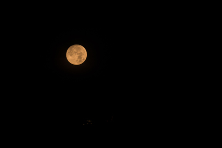 full moon at night and the light on the hill for abstract backgroundの写真素材