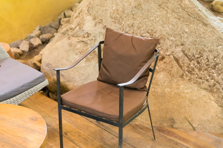 metal armchair and brown pillow in living roomの写真素材