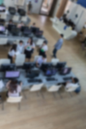 student use computer to access to internet for education in university (blurry defocused image)