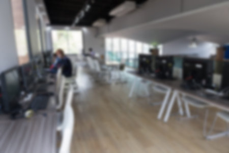 student use computer to access to internet for education in university (blurry defocused image)
