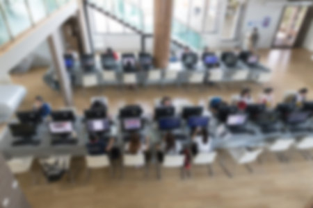 student use computer to access to internet for education in university (blurry defocused image)