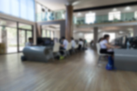 student use computer to access to internet for education in university (blurry defocused image)