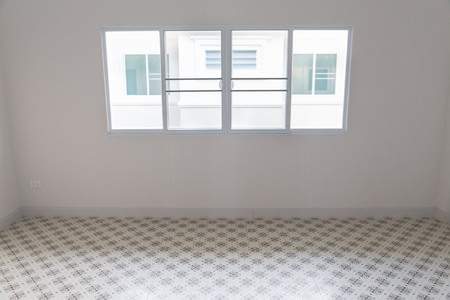 empty room with sliding window and beige tile floorのeditorial素材