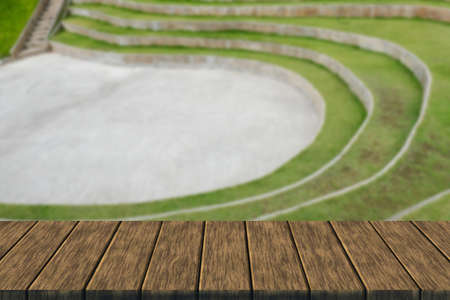 tiered seat of the amphitheater and outdoor stage (blur background with wood table top for display or montage your product)の写真素材