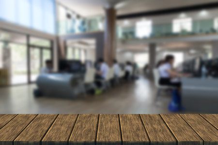 student use computer to access to internet for education in university  (blur background with wood table top for display or montage your product)の写真素材