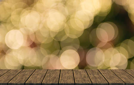 defocused blurry christmas bokeh light (blur background with wood table top for display or montage your product)の写真素材