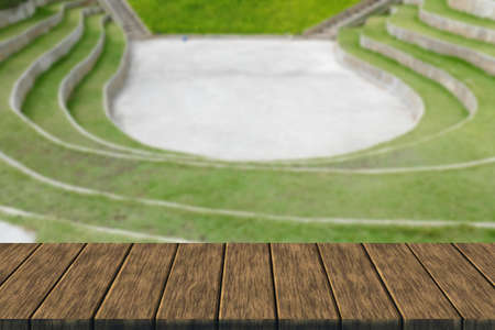 tiered seat of the amphitheater and outdoor stage (blur background with wood table top for display or montage your product)の写真素材