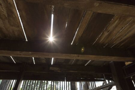 sunlight through the wooden floor of traditional Thai ancient houseの写真素材