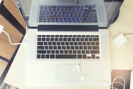 earphone and laptop computer notebook on wooden table, vintage toneの写真素材