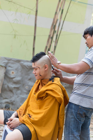 Chiang Mai, Thailand - April 30, 2016: man shave man's hair before buddhist monk ordination ceremony at Umong temple in Chiang Mai, Thailand on April 30, 2016.のeditorial素材