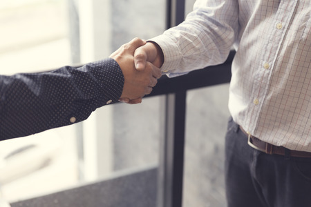 businessman handshaking for business cooperation and acquisiton concept, selective focus and vintage toneの写真素材