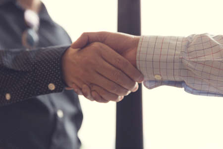 businessman handshaking for business cooperation and acquisiton concept, selective focus and vintage toneの写真素材