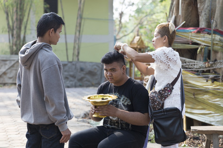 Chiang Mai, Thailand - April 30, 2016: parent cut hair of their son before buddhist monk ordination ceremony at Umong temple in Chiang Mai, Thailand on April 30, 2016.のeditorial素材