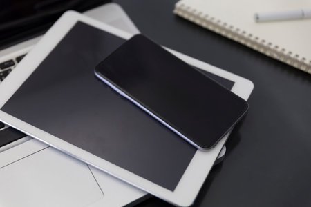 laptop computer, digital tablet and mobile phone on black table for working conceptの写真素材