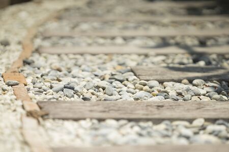 stone and wooden plank paving on walkway in gardenの写真素材