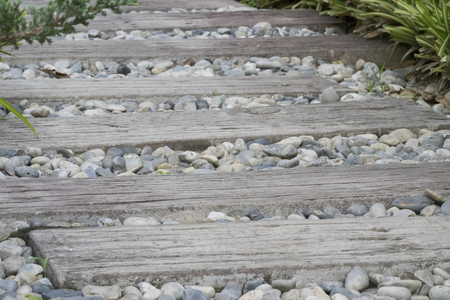stone and wooden plank paving on walkway in gardenの写真素材
