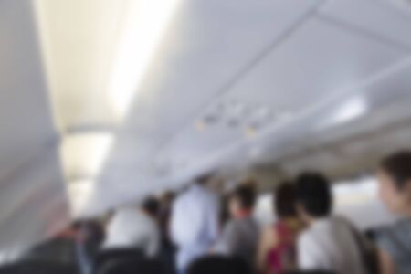 passenger walking in aisle in airplane cabin, blur backgroundの写真素材