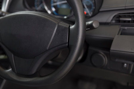 black steering wheel of new car automobile, selective focus