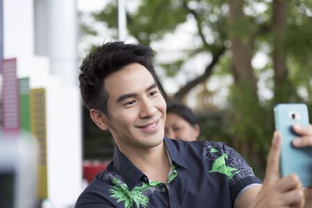 Chiang Mai, Thailand - May 21, 2016: Thanawat Wattanaputi or Pope, famous Thai actor, taking photo with his fan club at Toyota street fun festival in Chiang Mai, Thailand on May 21, 2016.のeditorial素材