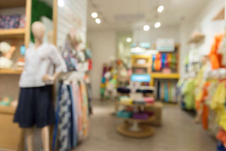 clothing selling in department store for use as shopping concept, blur background with bokeh lightの写真素材