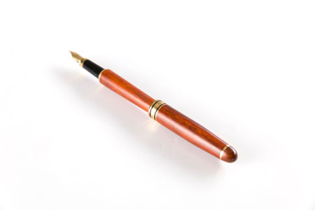 brown vintage fountain pen on white backgroundの写真素材