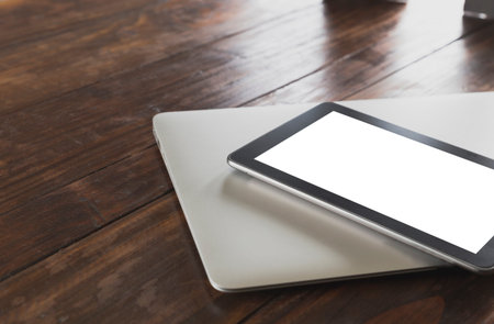 tablet, computer notebook on wooden office desk