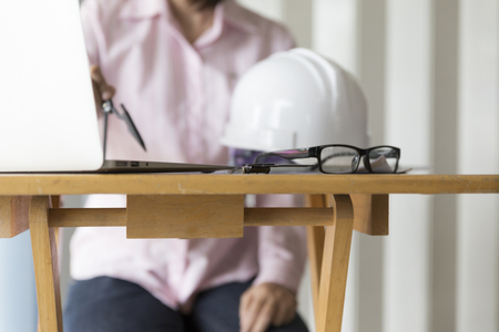 architect hand holding compass working on construction engineering project blueprintの写真素材