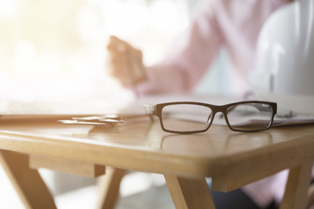 architect hand holding compass working on construction engineering project blueprintの写真素材