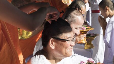 Lampang, Thailand - July 18, 2016: monk shave hair of man who will become buddhism monk in ordination ceremony at Bunyanupab temple in Lampang, Thailand on July 18, 2016.のeditorial素材