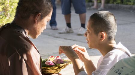 Lampang, Thailand - July 18, 2016: people cut hair of man who will become buddhism monk in ordination ceremony at Bunyanupab temple in Lampang, Thailand on July 18, 2016.のeditorial素材