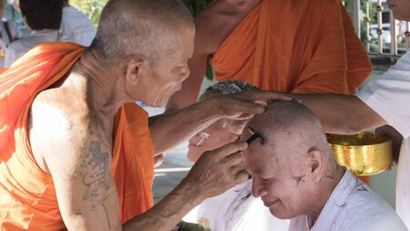 Lampang, Thailand - July 18, 2016: monk shave hair of man who will become buddhism monk in ordination ceremony at Bunyanupab temple in Lampang, Thailand on July 18, 2016.のeditorial素材