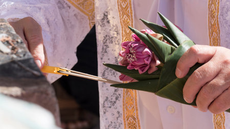 people holding pink lotus and lighting candle and incense in buddhism monk ordination ceremony