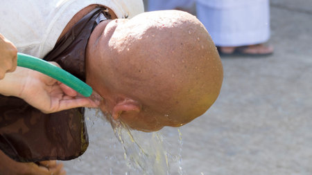 Lampang, Thailand - July 18, 2016: man who will become buddhism monk washing his head after shaving...
