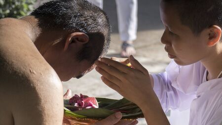 Lampang, Thailand - July 18, 2016: people cut hair of man who will become buddhism monk in ordination ceremony at Bunyanupab temple in Lampang, Thailand on July 18, 2016.のeditorial素材