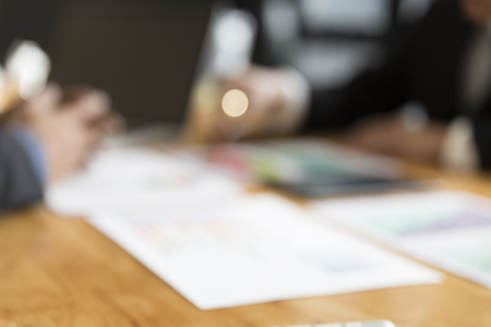 businessman meeting, analyzing and discussing with computer and paperwork document - blur for use as backgroundの写真素材