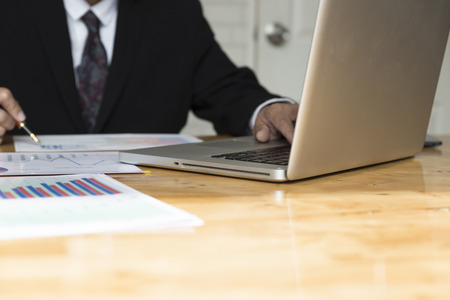 businessman working with chart diagram analysis paperwork document,  laptop computer on office deskの写真素材