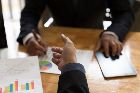 businessman meeting, analyzing and discussing with tablet and paperwork document