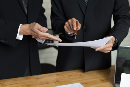 businessman meeting, analyzing and discussing with laptop computer and paperwork documentの写真素材