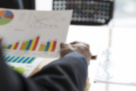 businessman working with chart diagram analysis paperwork document on office desk - blur for use as backgroundの写真素材