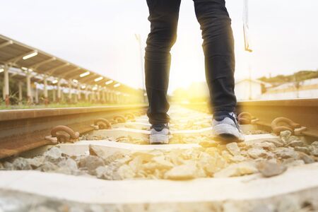 young woman holding map walking on railway at train station - travel conceptの写真素材