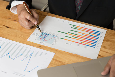 businessman working with chart diagram analysis paperwork document,  laptop computer on office desk