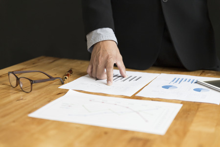businessman in suit analyze with market analysis business chart documentの写真素材
