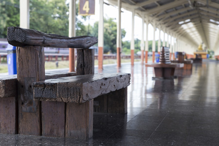 wooden chair seat bench at train stationの写真素材